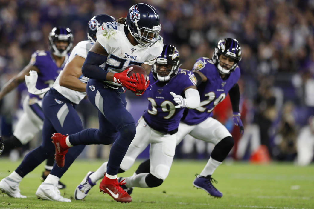Tennessee Titans running back Derrick Henry (22) runs against the Baltimore Ravens during the f ...