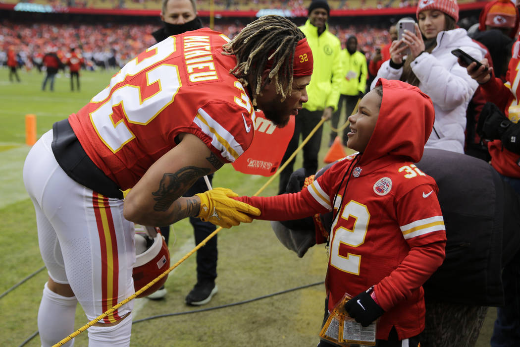 Kansas City Chiefs safety Tyrann Mathieu (32) interacts with a fan before an NFL divisional pla ...