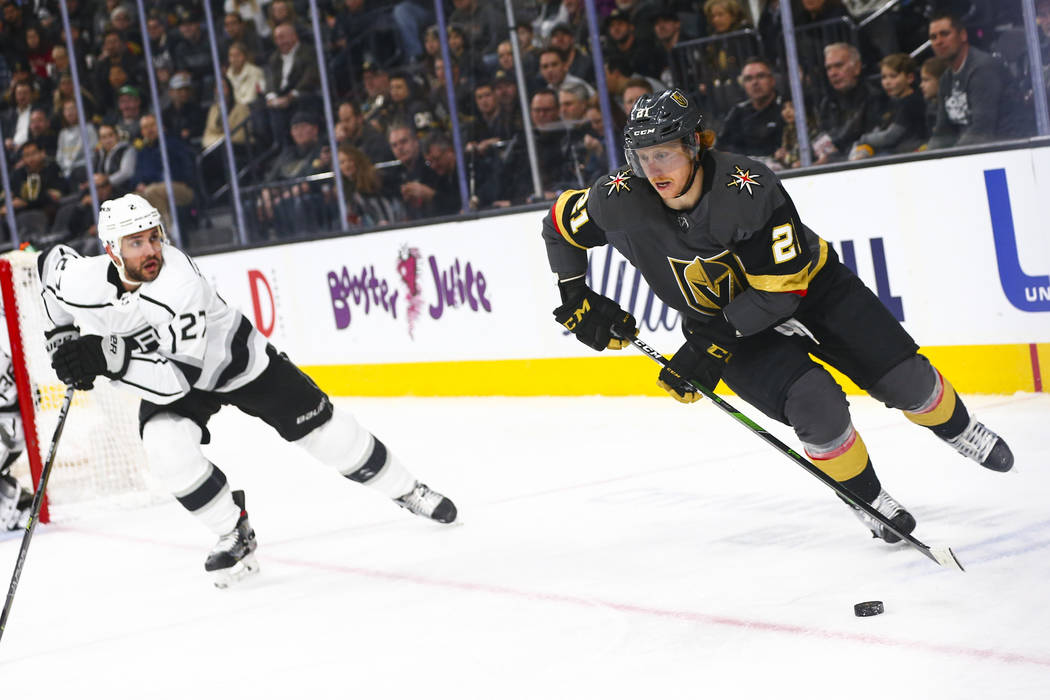 Golden Knights' Cody Eakin (21) skates with the puck against Los Angeles Kings' Alec Martinez ( ...