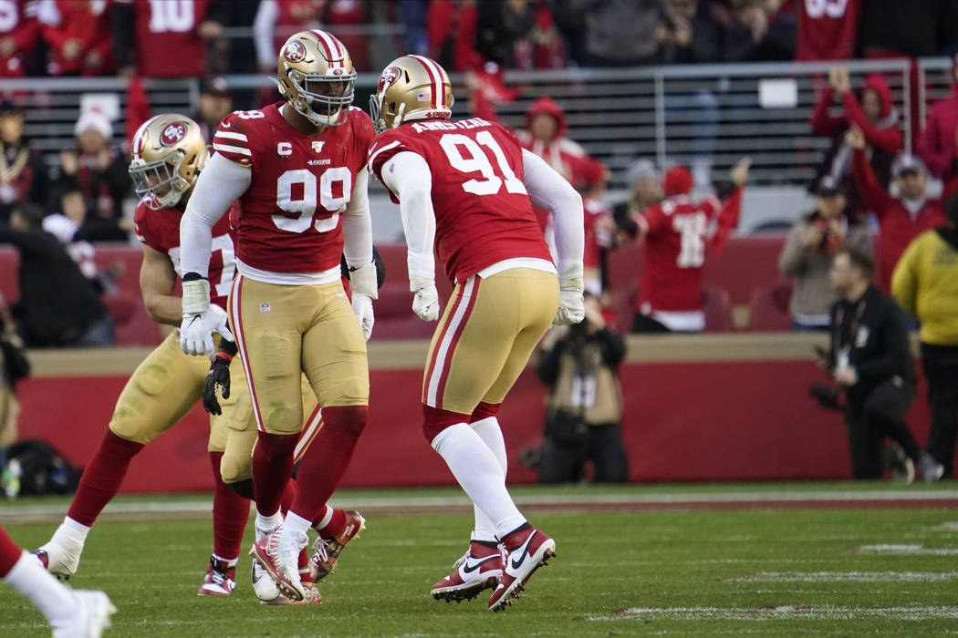 San Francisco 49ers defensive tackle DeForest Buckner (99) celebrates a play with defensive end ...