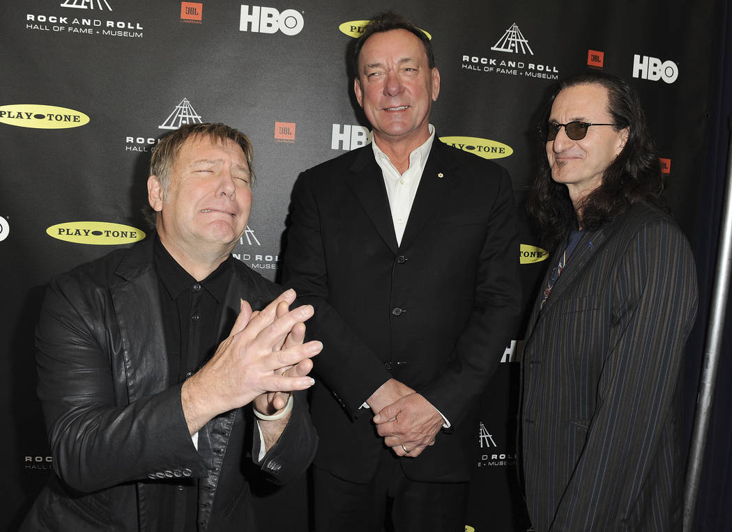 Alex Lifeson, left, Neil Peart and Geddy Lee of Rush at the Rock and Roll Hall of Fame Inductio ...