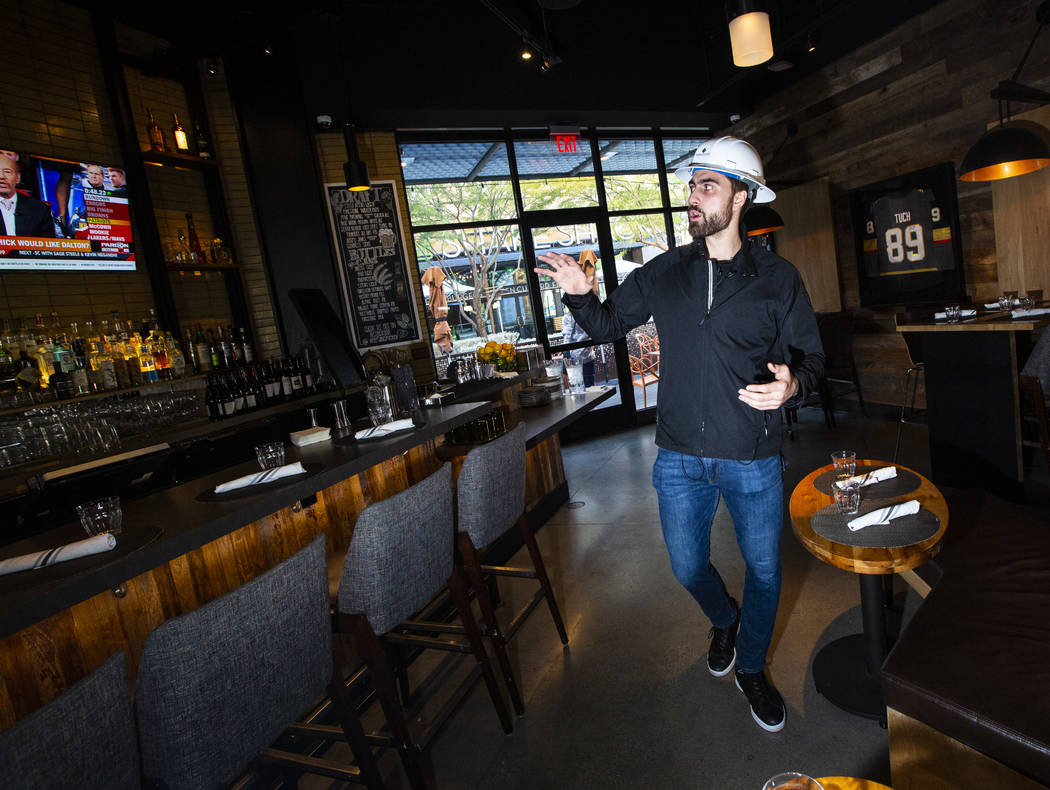 Golden Knights' Alex Tuch talks during a tour of the current Wolfgang Puck Bar & Grill spac ...