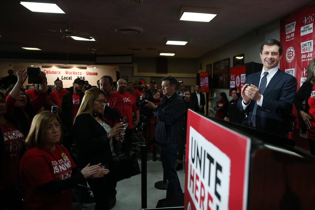 Democratic presidential candidate Pete Buttigieg, right, gets a standing ovation after particip ...