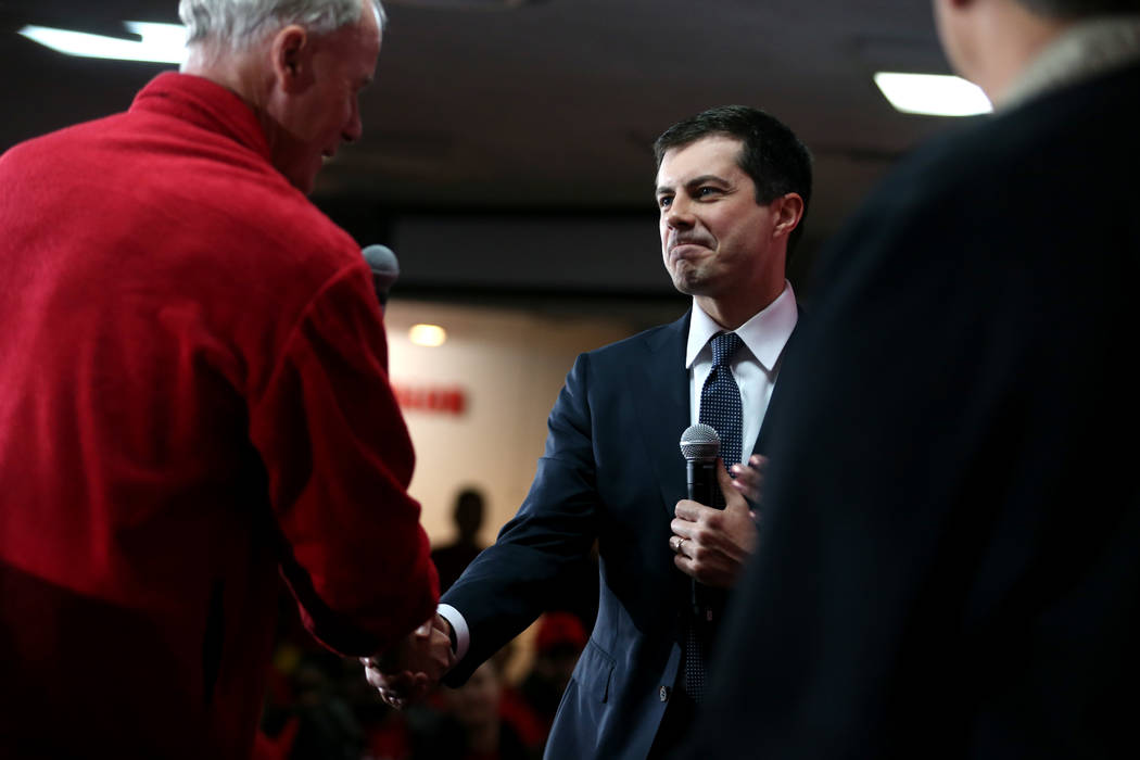Democratic presidential candidate Pete Buttigieg, center, shakes hands with D. Taylor, presiden ...