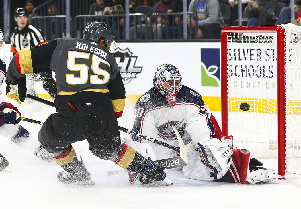 Columbus Blue Jackets' goaltender Elvis Merzlikins (90) blocks a shot from Golden Knights' Keeg ...