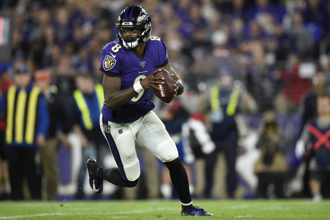 Baltimore Ravens quarterback Lamar Jackson (8) works out of the pocket against the Tennessee Ti ...