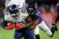 Baltimore Ravens cornerback Marcus Peters (24) hits Tennessee Titans running back Derrick Henry ...