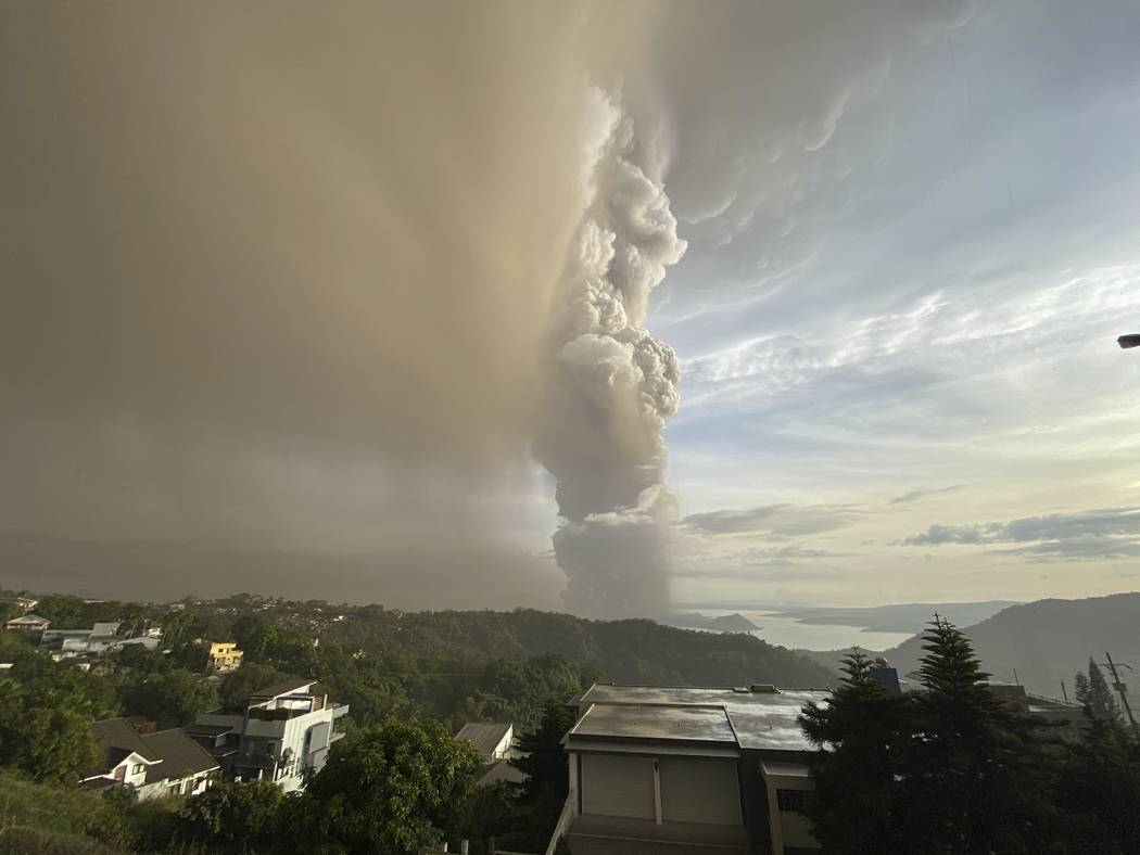 Plumes of smoke and ash rise from as Taal Volcano erupts Sunday Jan. 12, 2020, in Tagaytay, Cav ...