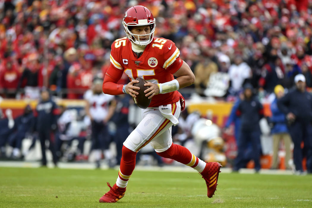 Kansas City Chiefs quarterback Patrick Mahomes (15) scrambles during the first half of an NFL d ...