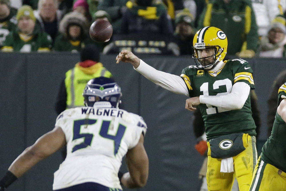 Green Bay Packers' Aaron Rodgers throws during the second half of an NFL divisional playoff foo ...