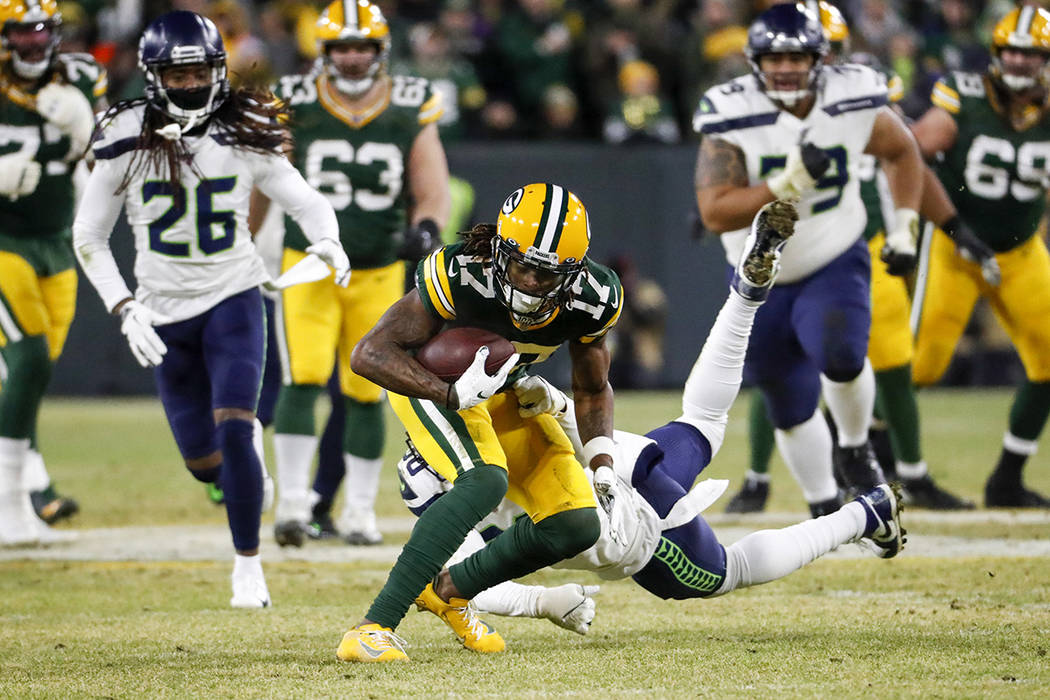 Green Bay Packers' Davante Adams runs after a catch during the first half of an NFL divisional ...