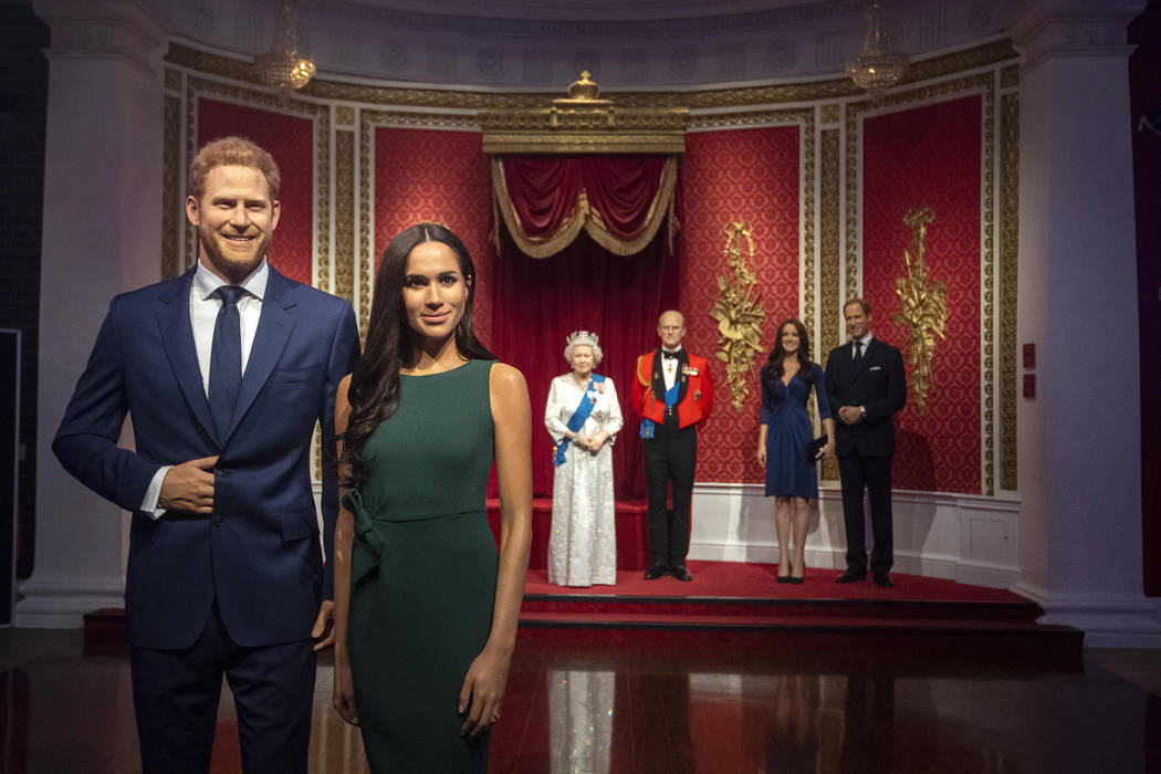 The figures of Britain's Prince Harry and Meghan, Duchess of Sussex, left, are moved from their ...