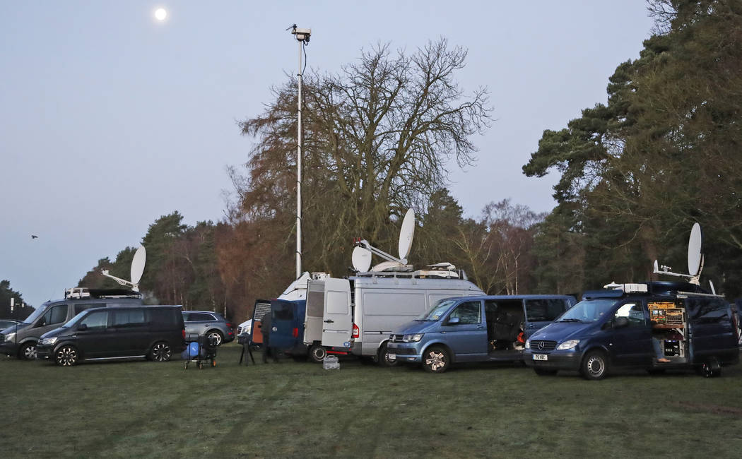 Media prepares in the early morning at the entrance of the castle in Sandringham, England, Mond ...