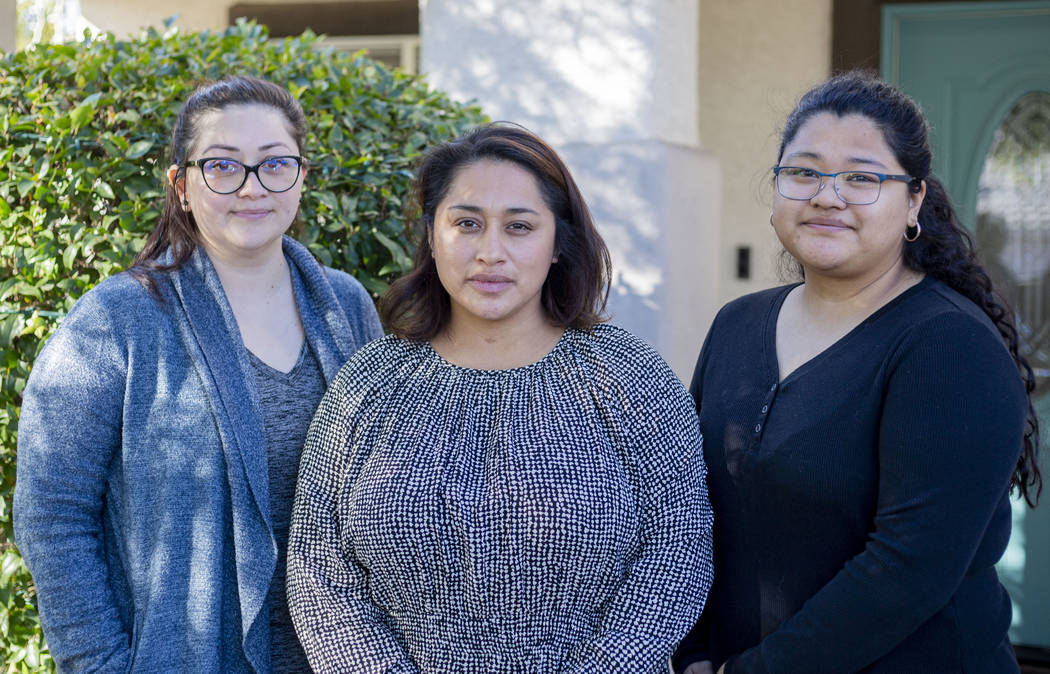 Sisters Mariela Amaro, left, Ruth Neall, center, and Andrea Lopez pose for a photograph outside ...