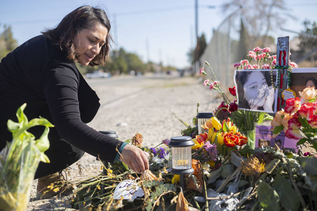 Ruth Neall puts fresh flowers at the memorial on Monday, Jan. 13, 2020, at the spot where her m ...