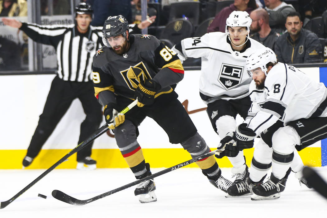 Golden Knights' Alex Tuch (89) battles for the puck against Los Angeles Kings' Nikolai Prokhork ...