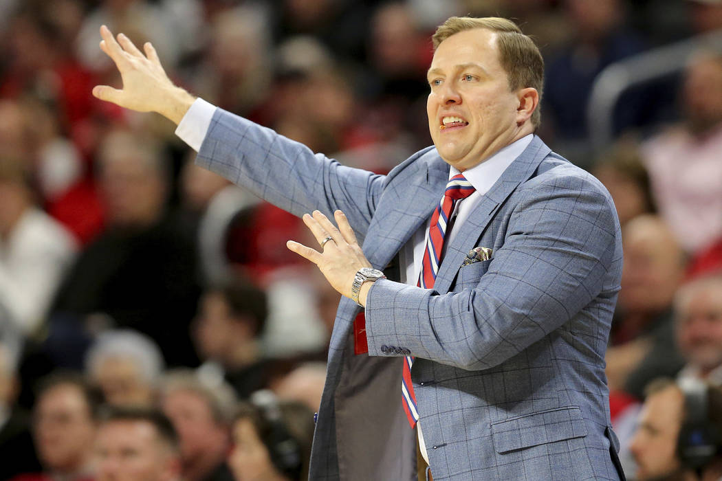 UNLV coach T.J. Otzelberger gestures during the first half of the team's NCAA college basketbal ...