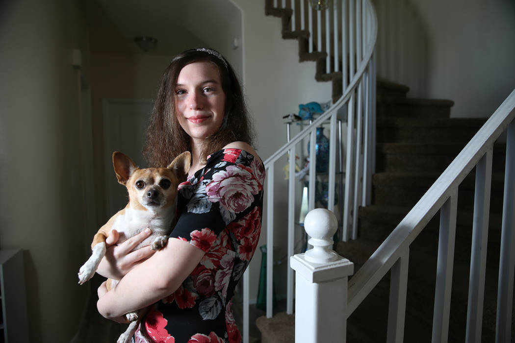 Alyssa Canning, 16, holds her dog at her home in Las Vegas, Thursday, Aug. 15, 2019. Canning wa ...