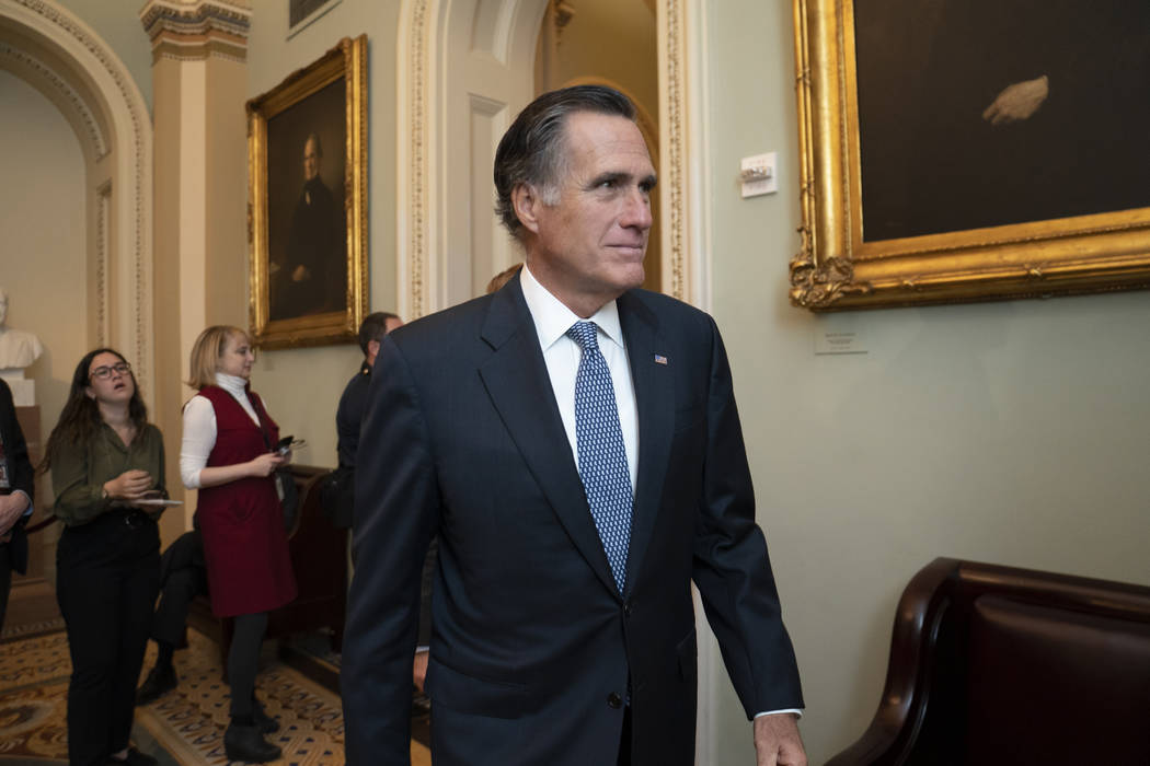 Sen. Mitt Romney, R-Utah, arrives for a closed meeting with fellow Republicans about the loomin ...