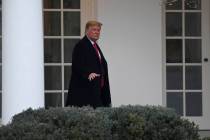 President Donald Trump walks along the colonnade of the White House in Washington, Monday, Jan. ...