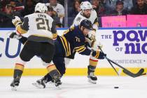 Buffalo Sabres forward Evan Rodrigues (71) is taken down by Vegas Golden Knights forward Cody E ...