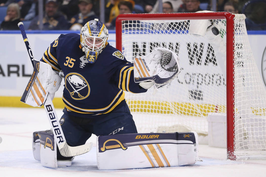 The puck hits the post behind Buffalo Sabres goalie Linus Ullmark (35) during the second period ...