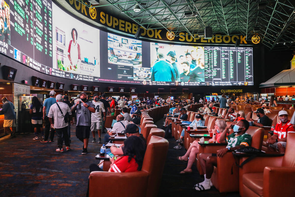 A packed house watches the screens at the Sports Book at Westgate in Las Vegas, Sunday, Sept. 1 ...