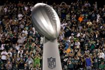 A giant replica of the Vince Lombardi Trophy is wheeled onto the field before an NFL football g ...