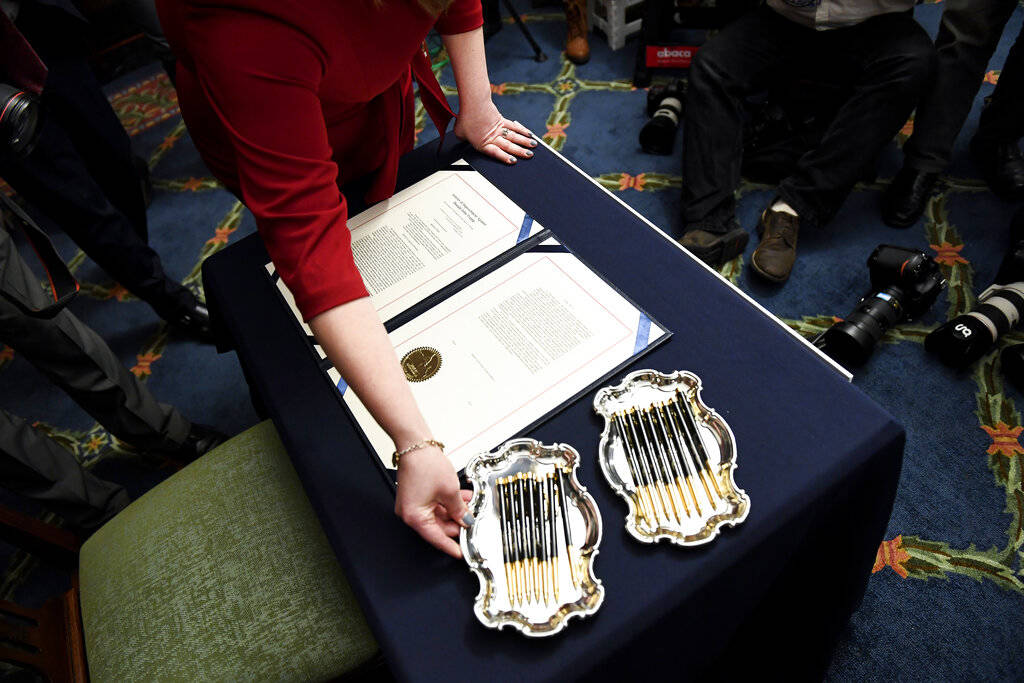 UNITED STATES - JANUARY 15: A clerk places a tray of pens before Speaker of the House Nancy Pel ...