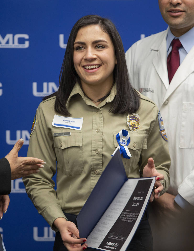 Miranda Smith, paramedic with MedicWest, receives a certificate of appreciation during a Univer ...