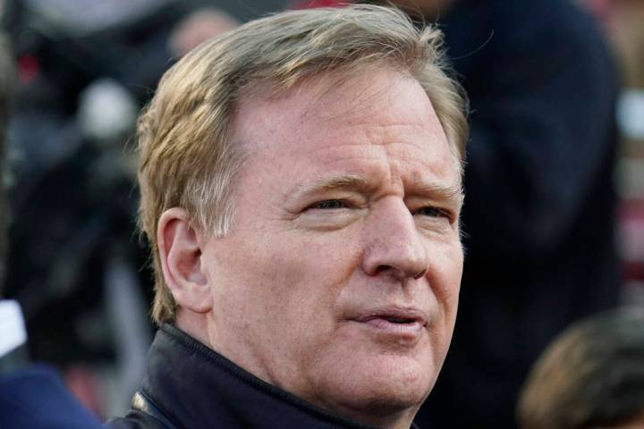 NFL Football Commissioner Roger Goodell watches warmups before an NFL divisional playoff footba ...