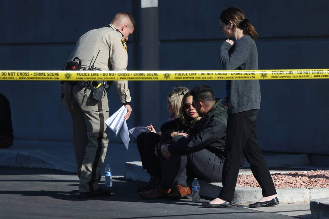 People wait as Las Vegas police investigate an officer-involved shooting that occurred in the 6 ...
