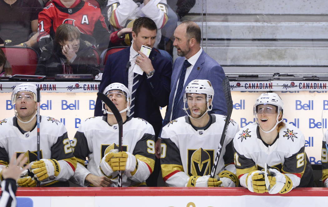 Vegas Golden Knights new head coach Peter DeBoer talks to one of his coaches on the bench as th ...