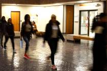 In this Nov. 19, 2019, photo, asylum seekers from Central America and Cuba follow an Immigratio ...
