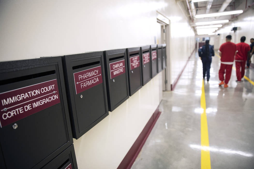 Mail boxes for various departments line a hallway as detainees walk through the Stewart Detenti ...