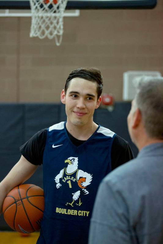 Junior Ethan Speaker, left, speaks with Boulder City basketball coach John Balistere during pra ...