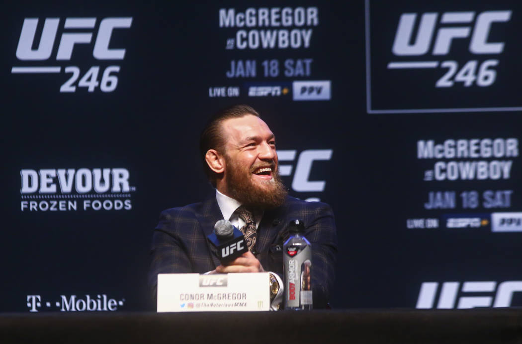 Conor McGregor reacts while talking about Donald "Cowboy" Cerrone, not pictured, during a press ...