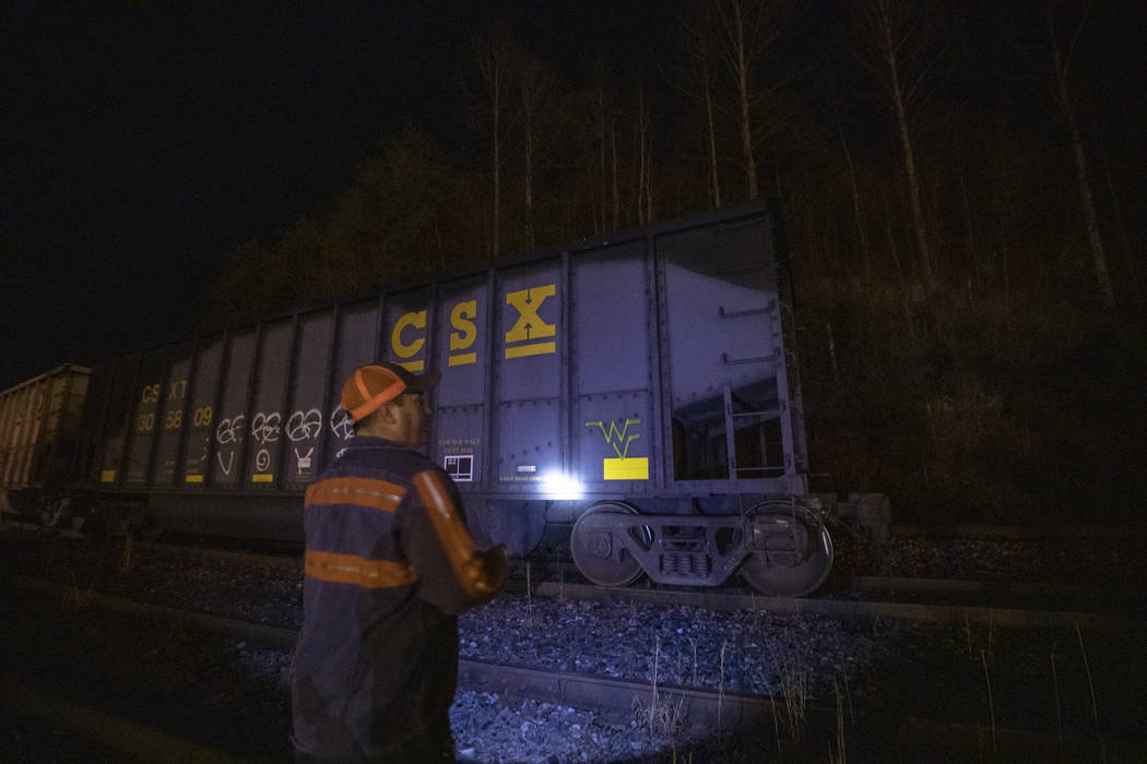 In this Monday, Jan. 13, 2020 photo, Richie Noble, a coal miner at Quest Energy, shines a flash ...