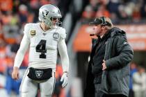 Oakland Raiders quarterback Derek Carr (4) and head coach Jon Gruden discuss a play call during ...