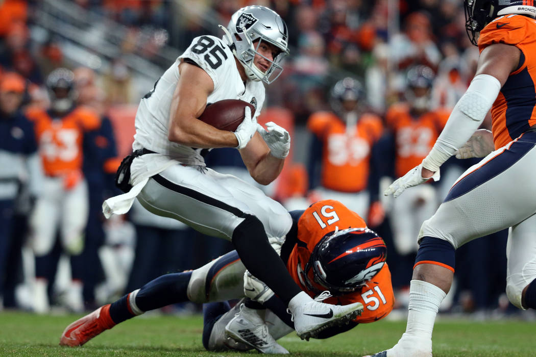 Oakland Raiders tight end Derek Carrier (85) is tackled by Denver Broncos inside linebacker Tod ...