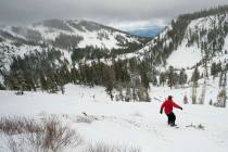 A snowboarder drops into a canyon at Alpine Meadows in Lake Tahoe, Calif. Authorities say one p ...