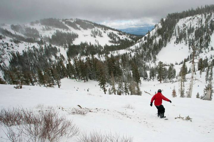 A snowboarder drops into a canyon at Alpine Meadows in Lake Tahoe, Calif. Authorities say one p ...