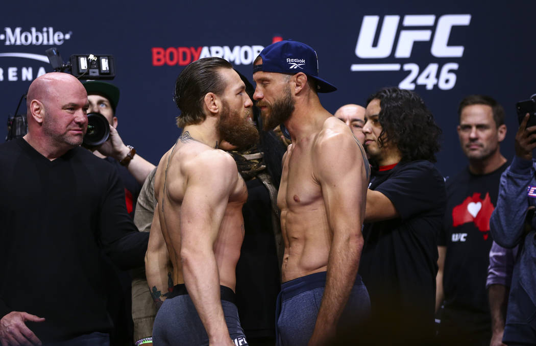 Conor McGregor, left, faces off against Donald "Cowboy" Cerrone ahead of their welter ...