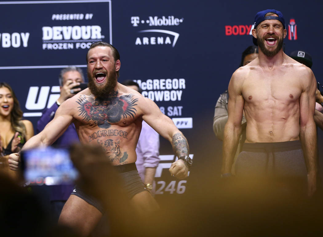 Conor McGregor, left, and Donald "Cowboy" Cerrone poses for photos ahead of their wel ...