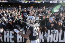 Oakland Raiders tight end Darren Waller (83) fires up the crowd in the "Black Hole" b ...