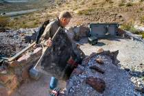 Richard Roman continues to clean out his cave after being evicted by Boulder City in the hills ...