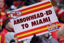 Fans hold signs during the second half of the NFL AFC Championship football game between the Ka ...