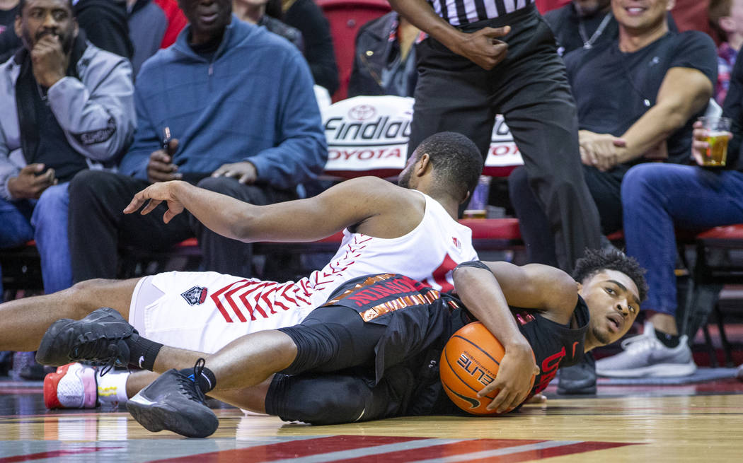 UNLV Rebels guard Bryce Hamilton (13, right) grab a loose ball on the court from New Mexico Lob ...