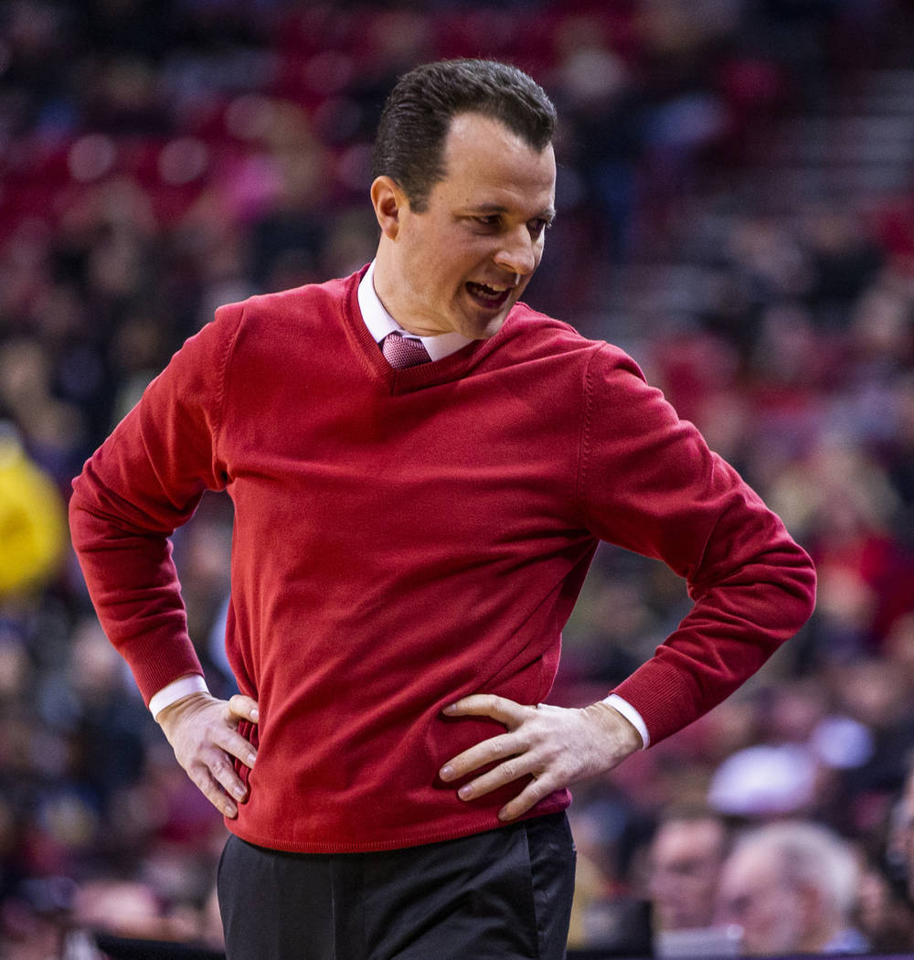 New Mexico Lobos head coach Paul Weir counsels his players on the bench versus the UNLV Rebels ...