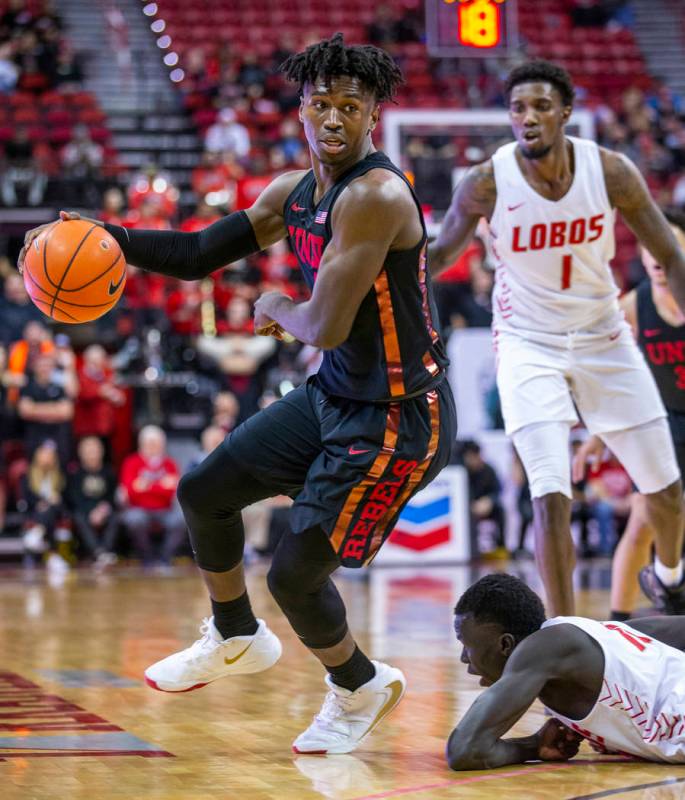 UNLV Rebels forward Donnie Tillman (2) looks to drive the lane as New Mexico Lobos guard Makuac ...